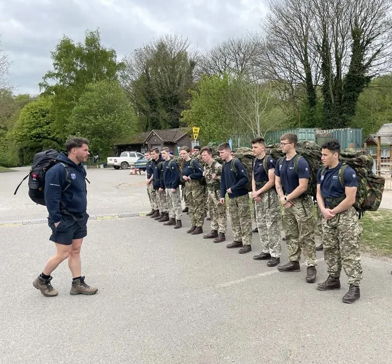 Alex briefing a squad lined up in training kit
