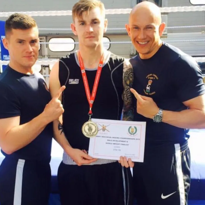 Alex and a fellow coach with a medal-winning boxer