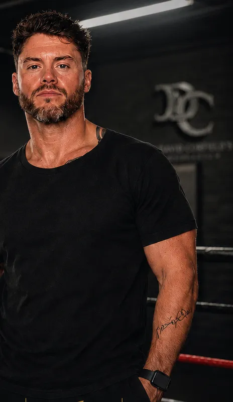 Alex Shepherd, Coach Shep, standing in the boxing ring at David Corfield Gymnasium